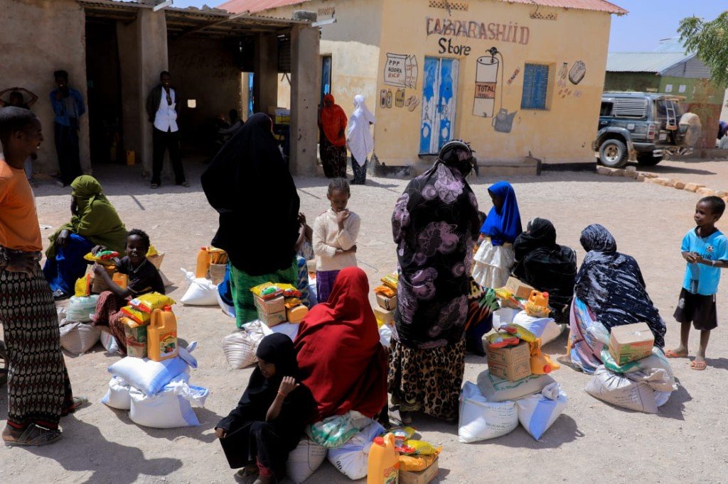 Community members receiving food and water supplies
