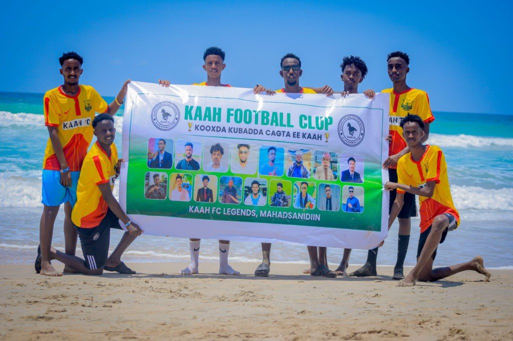 Kaah FC team with club banner on the beach